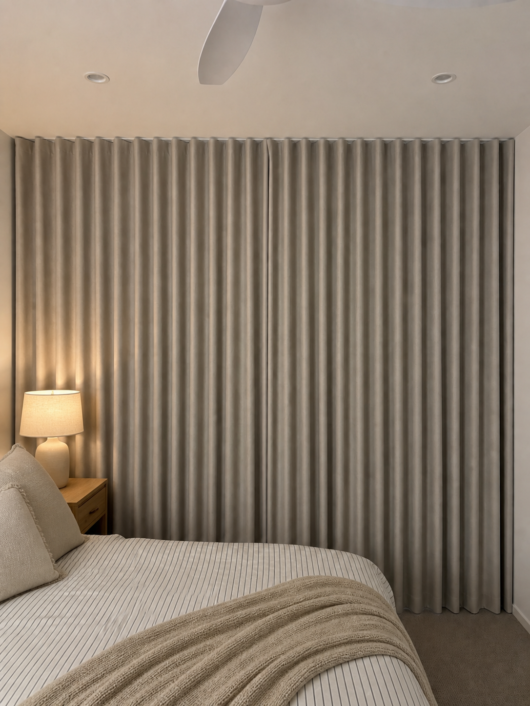 Blockout curtains framing a bedroom window in a Brisbane home