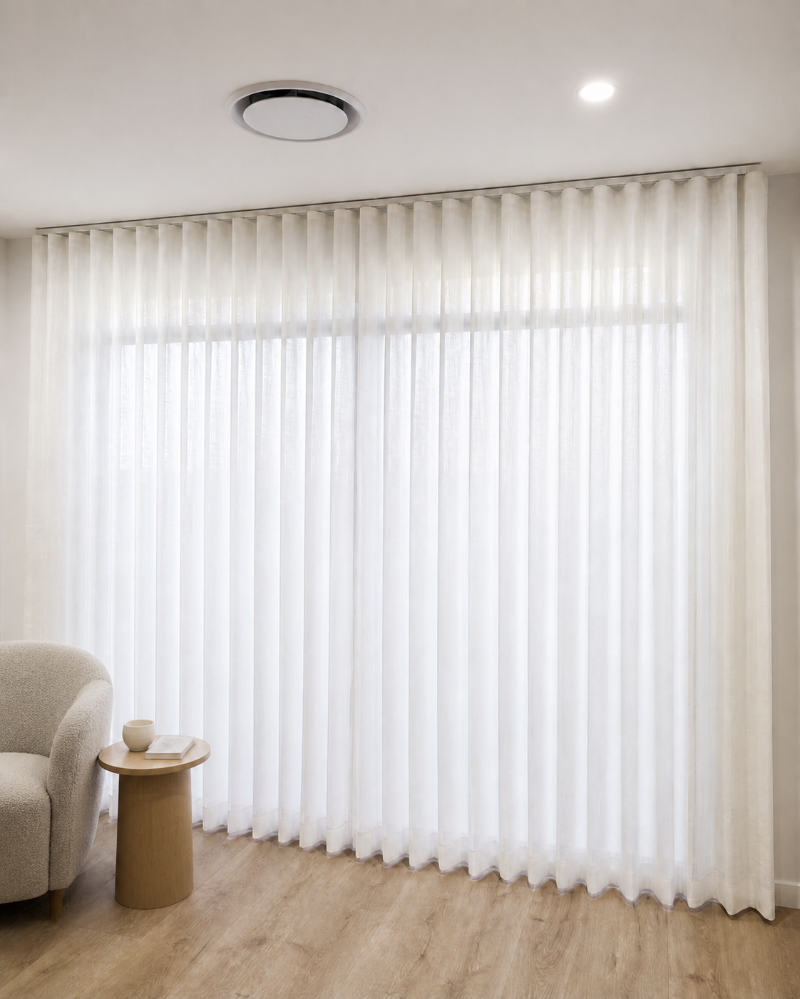 Sheer curtains diffusing natural light across a Brisbane living room