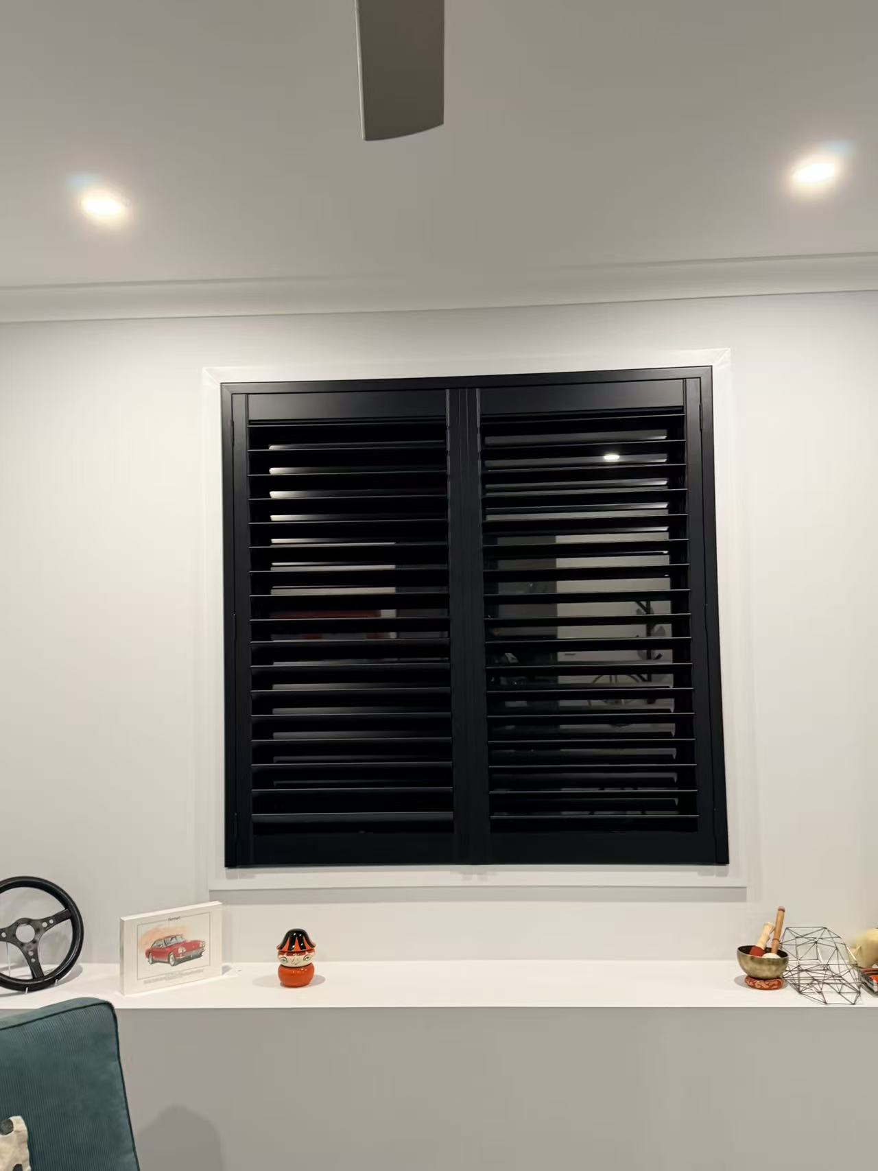 Black plantation shutters installed in a Greenbank home