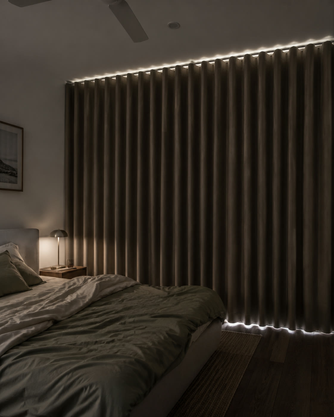 Dark taupe blockout curtains closed wall to wall in a bedroom at pre-dawn